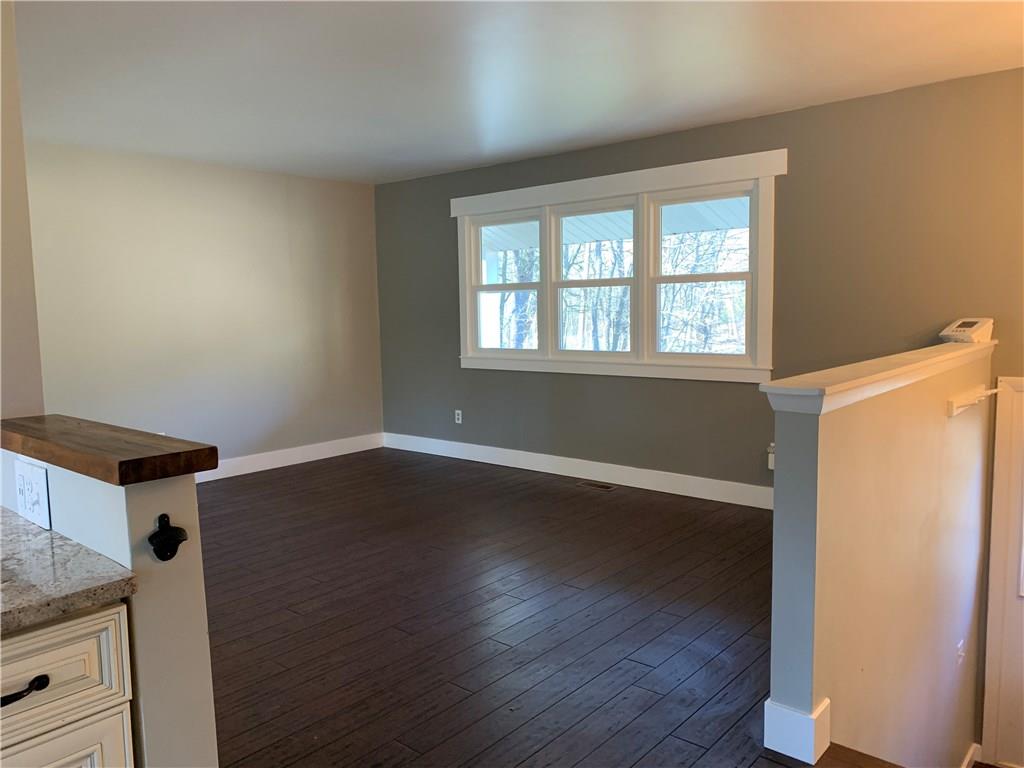 450 Leslie Road Valencia, PA 16059 - Photo 9 of 25 The living room overlooks the wooded lot and stream that flows through the front of the property.