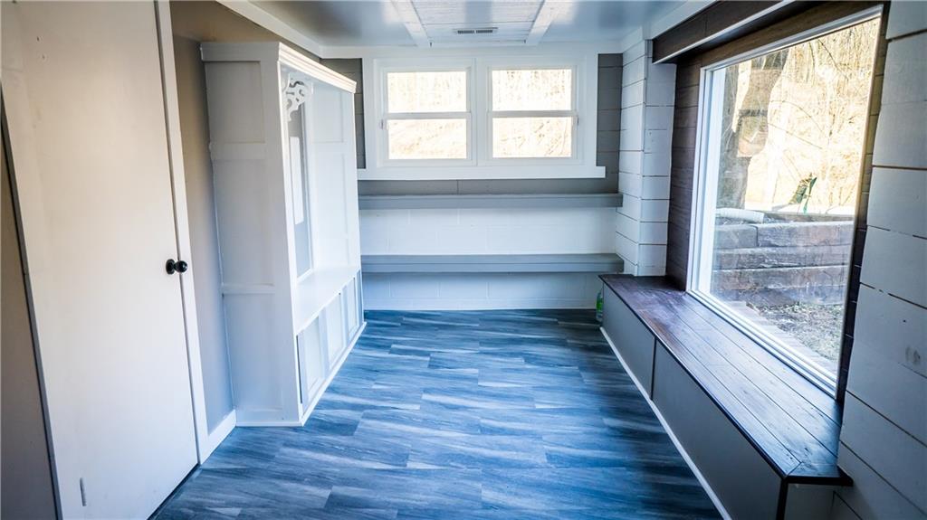 450 Leslie Road Valencia, PA 16059 - Photo 10 of 25 Once the garage part of the house, this area has been finished to create a versatile space which could be used for and office, workshop or craft room and overlooks the side and front with lots of natural-light producing windows.