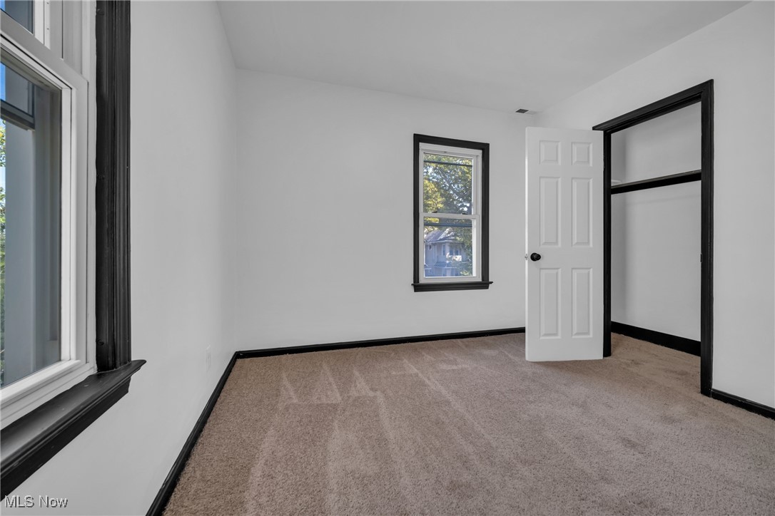 916 Nathaniel Road Cleveland, OH 44110 - Photo 22 of 28 Unfurnished bedroom with light colored carpet and a closet