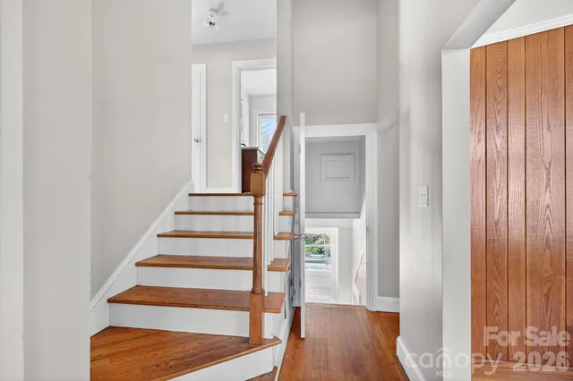 a view of a hallway with wooden floor and entryway
