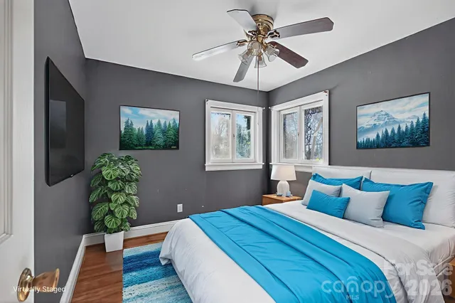 a bedroom with a large bed and a chandelier