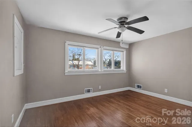a view of a room with wooden floor and windows