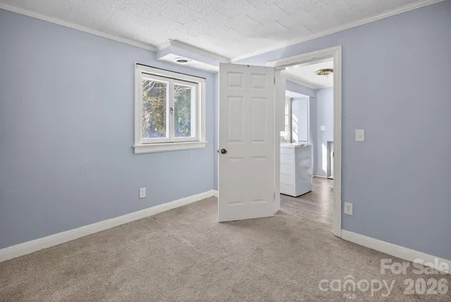 an empty room with windows and closet