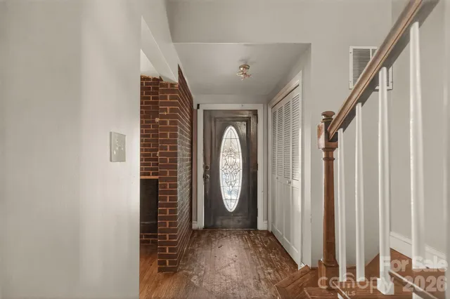 a view of an entryway with wooden floor