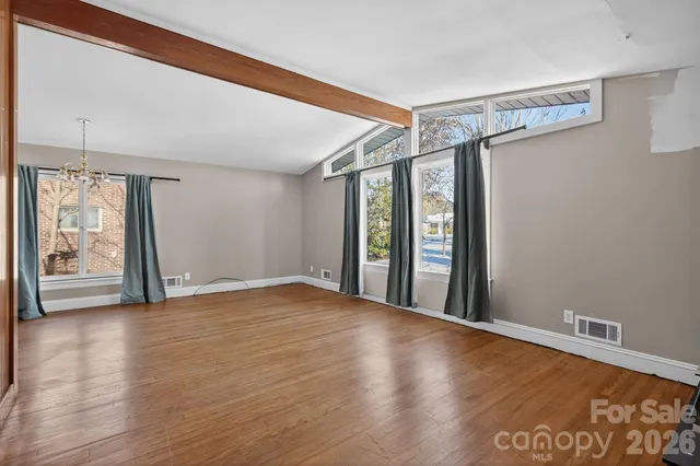 a view of an empty room with glass door