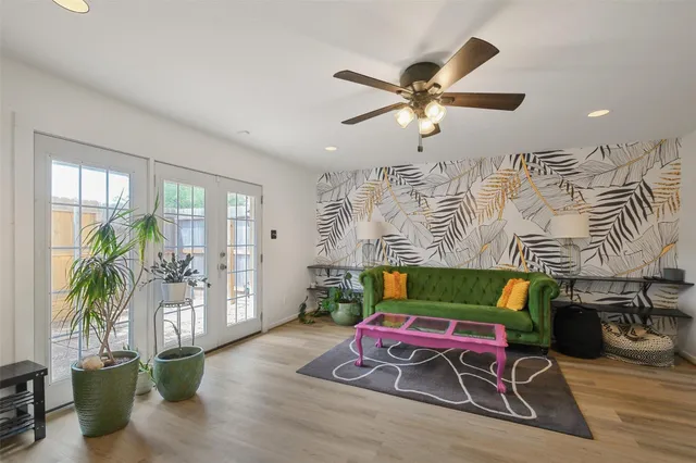 a living room with furniture and a floor to ceiling window