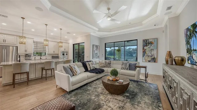 a living room with furniture and a view of kitchen