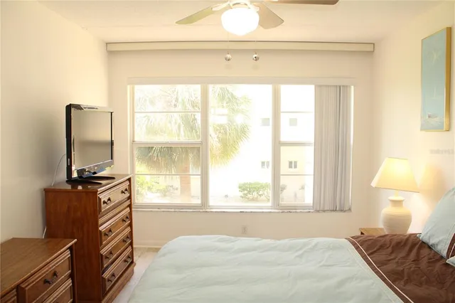 a bedroom with bed and window