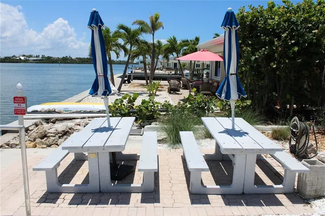 a backyard of a house with table and chairs
