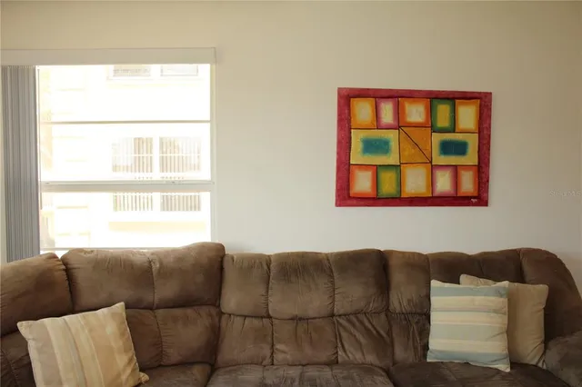 a view of workspace with wooden floor windows cabinet and flat screen tv