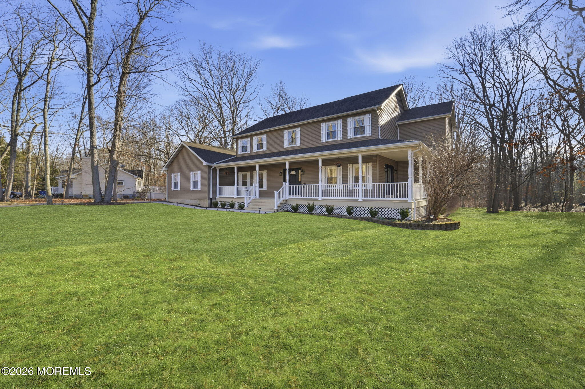 a front view of house with yard and green space