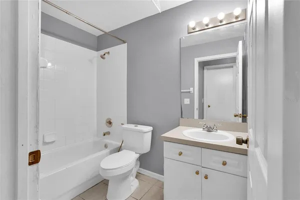 a bathroom with a toilet sink shower and mirror
