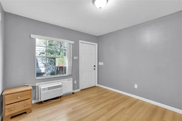 a view of a room with wooden floor and window