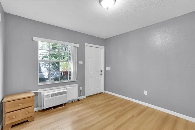a view of a room with wooden floor and window