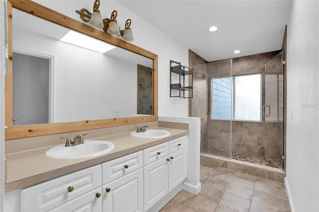 a bathroom with a sink double vanity and a mirror