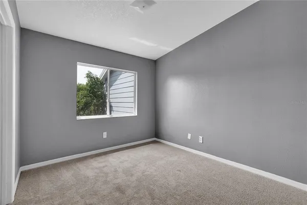 an empty room with windows and closet