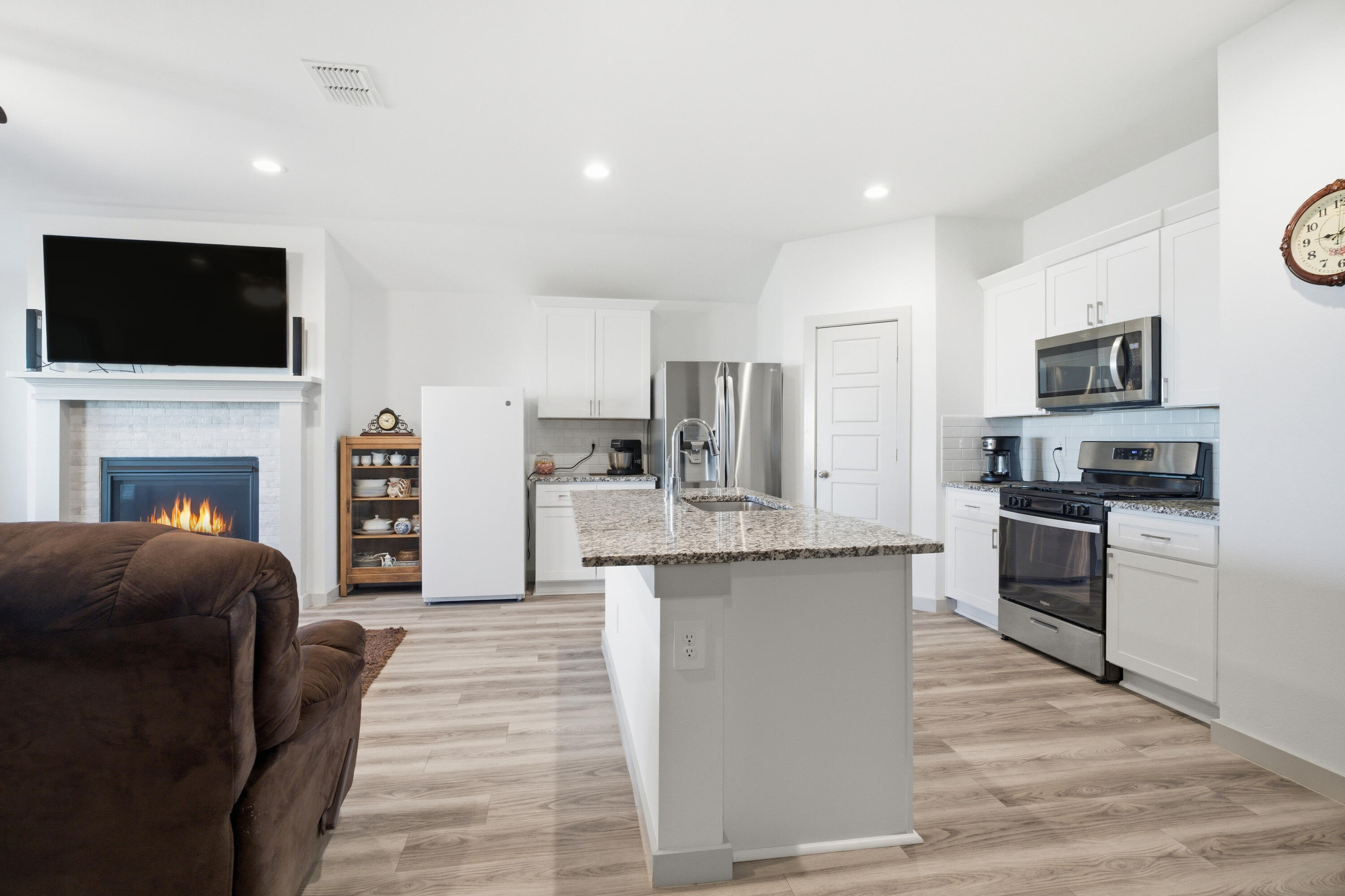 2902 133rd Street Lubbock, TX 79423 - Photo 14 of 38 a living room with stainless steel appliances furniture a flat screen tv and a kitchen view