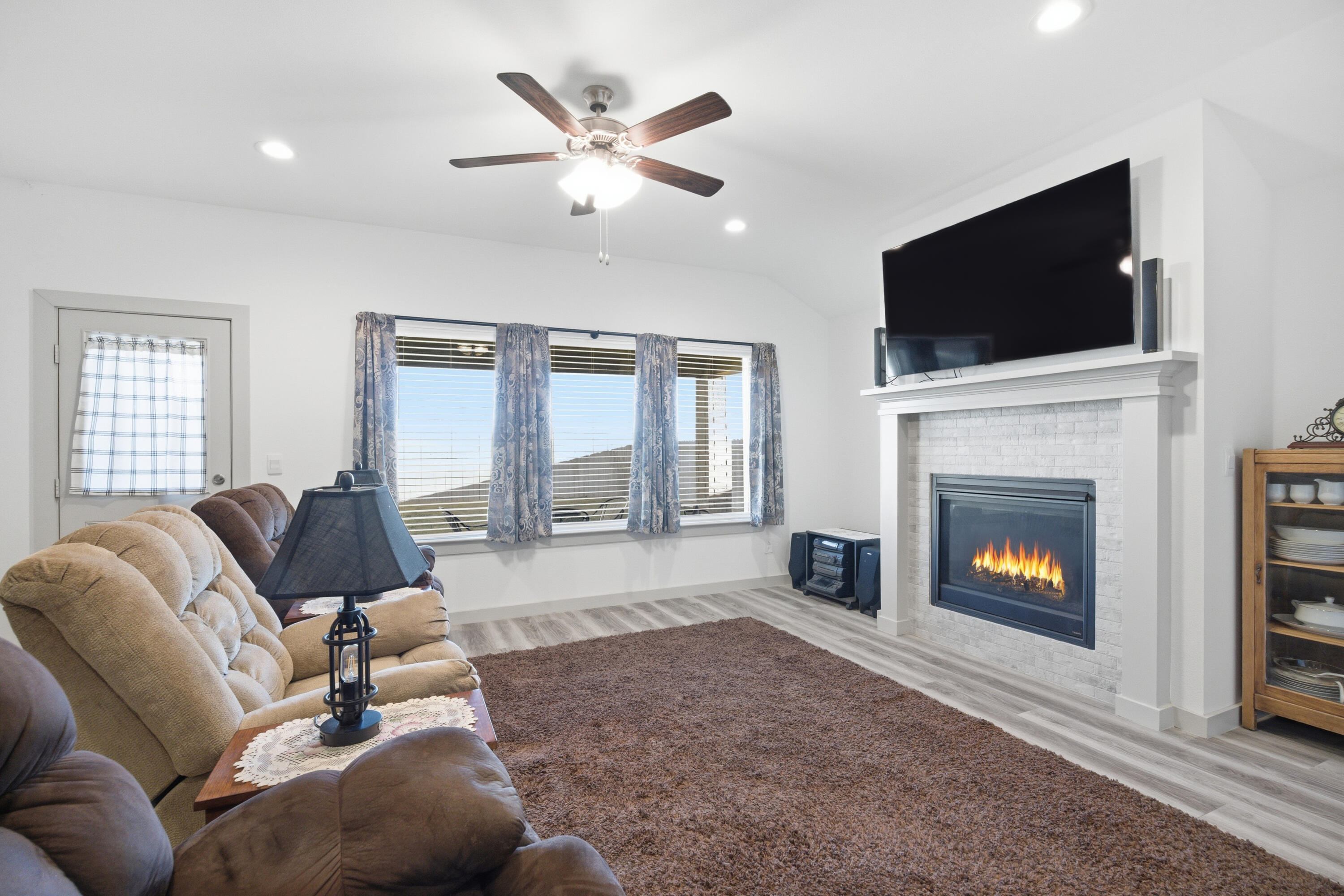2902 133rd Street Lubbock, TX 79423 - Photo 5 of 38 a living room with furniture fireplace and flat screen tv