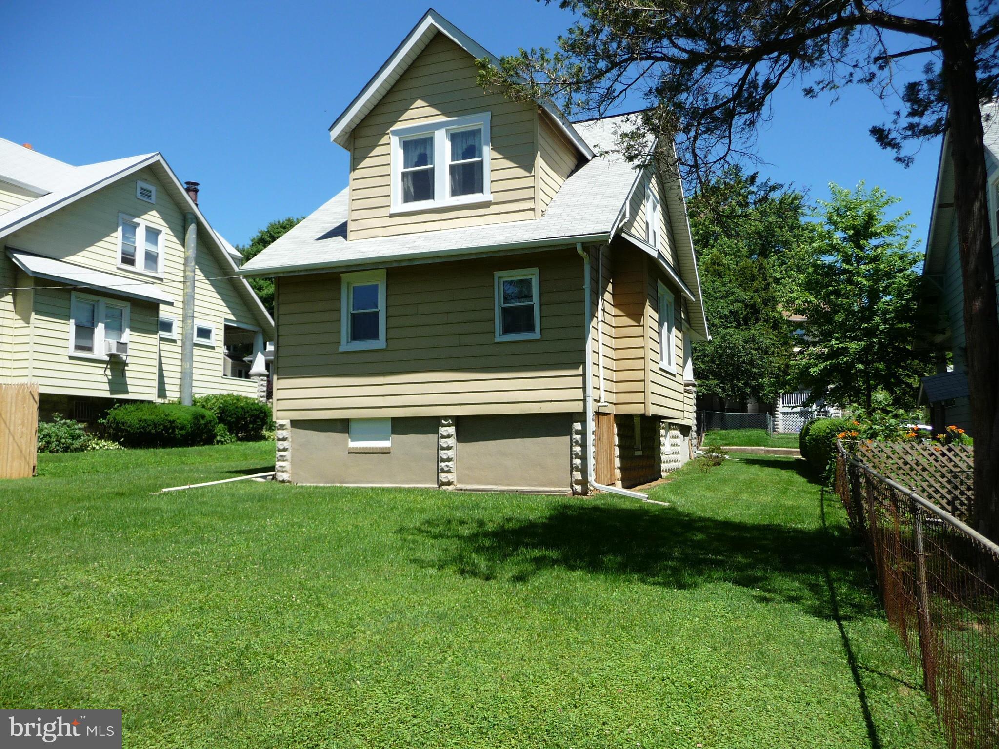 409 Walcott Road Baltimore, MD 21206 - Photo 26 of 27 a front view of a house with a yard and trees