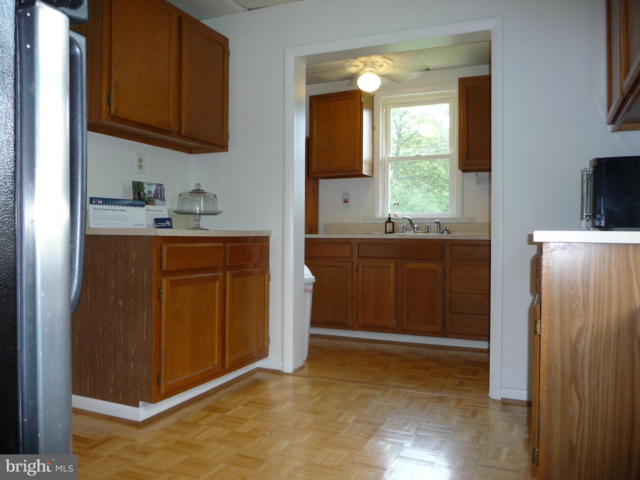 409 Walcott Road Baltimore, MD 21206 - Photo 7 of 27 a kitchen with stainless steel appliances granite countertop a refrigerator and a sink