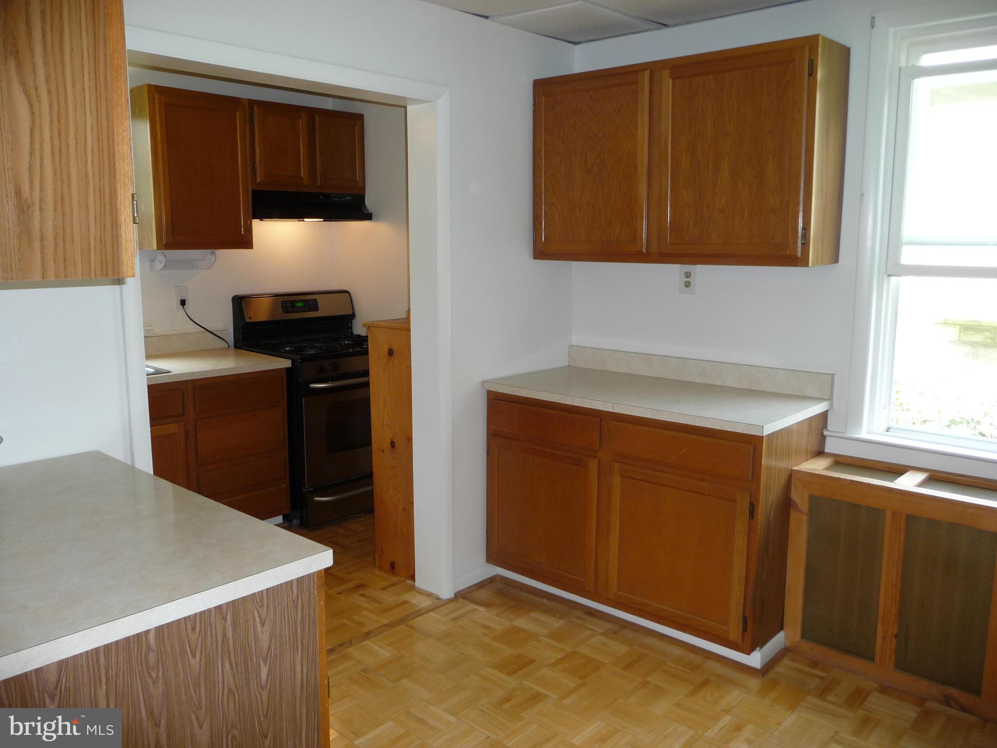 409 Walcott Road Baltimore, MD 21206 - Photo 9 of 27 a kitchen with stainless steel appliances a stove and a microwave