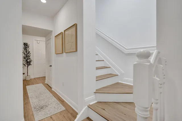 a view of living room with wooden floor and white cabinets
