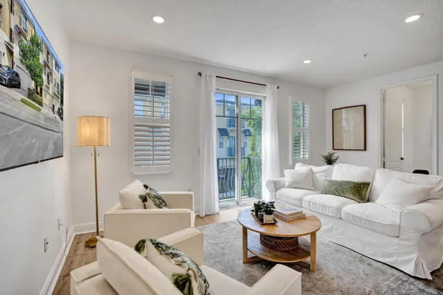 a view of hall way with furniture and wooden floor