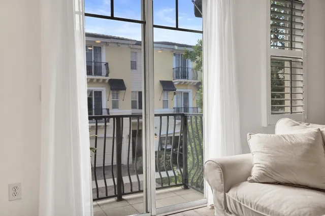 a dining room with wooden floor and a chandelier