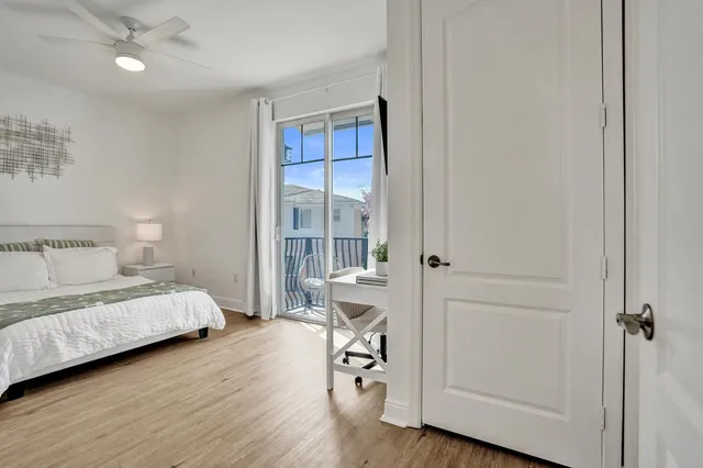 a view of a workspace with wooden floor and a bathroom