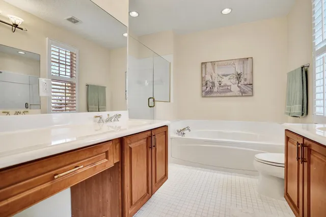 a bathroom with a tub double sink and mirror
