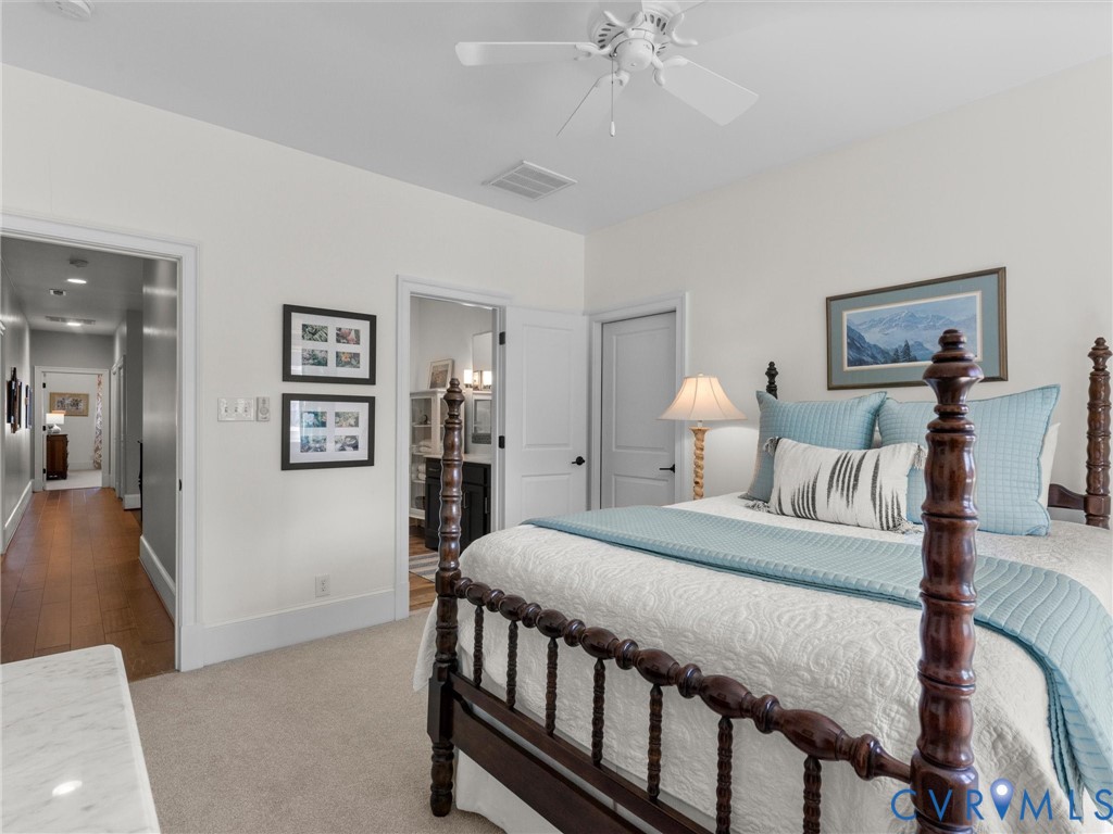 16131 Binley Road Midlothian, VA 23112 - Photo 77 of 99 a bedroom with a bed and a chandelier