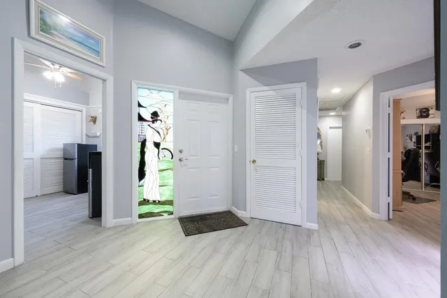 a view of a hallway view with wooden floor and staircase