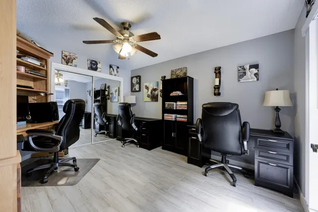 a view of a workspace with furniture and a window