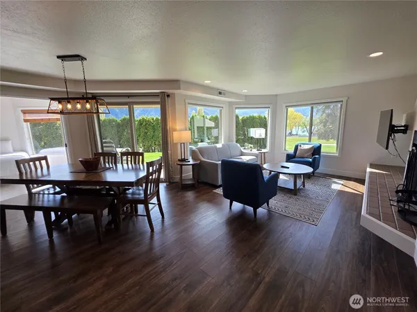 a view of a dining room with furniture window and wooden floor