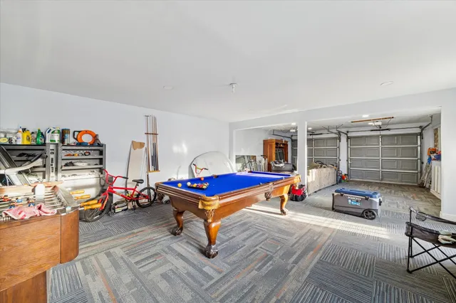a living room with furniture a flat screen tv and gym equipment