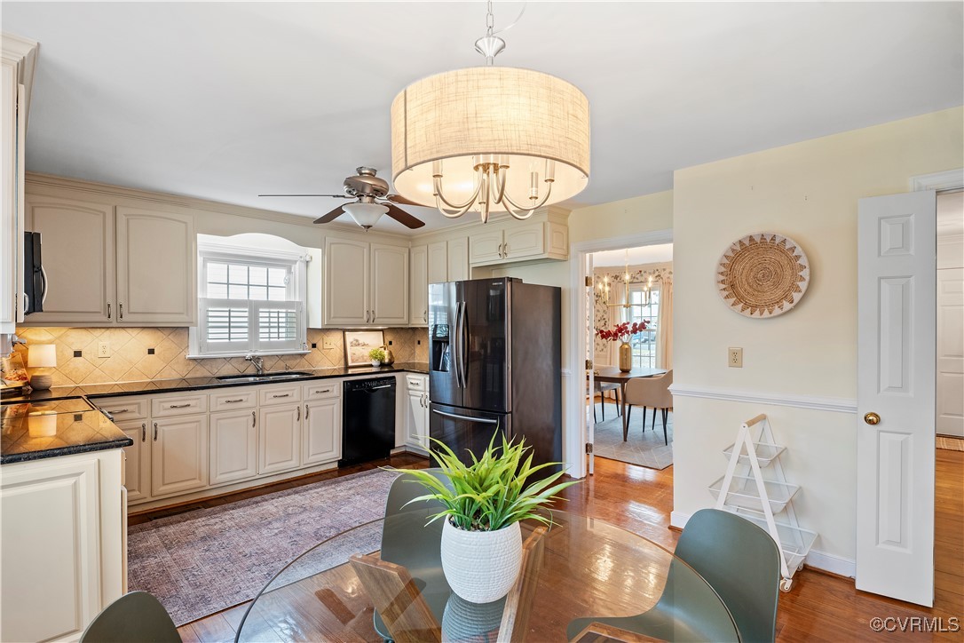 2208 Persimmon Trek Henrico, VA 23233 - Photo 11 of 44 a kitchen with stainless steel appliances granite countertop a refrigerator a stove a sink dishwasher and white cabinets with wooden floor