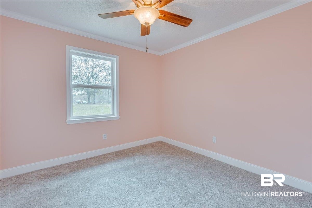 440 Dykes Road Mobile, AL 36608 - Photo 20 of 49 Spare room with ceiling fan, baseboards, carpet, and ornamental molding