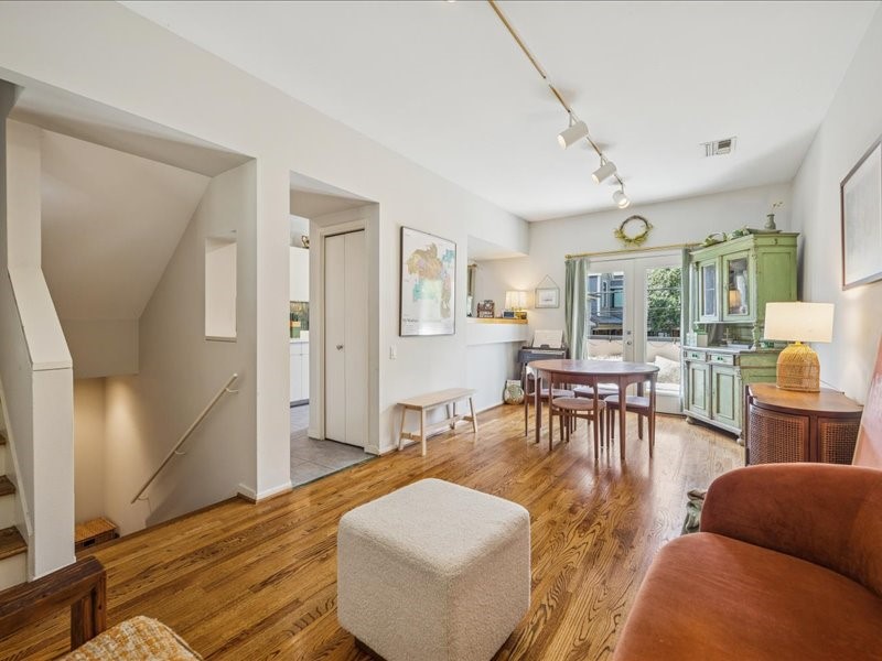 1369 Arlington Street, Unit 1369 Houston, TX 77008 - Photo 14 of 35 a living room with furniture and a dining table with wooden floor