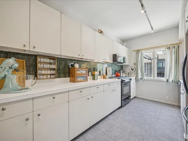 a kitchen with cabinets and window