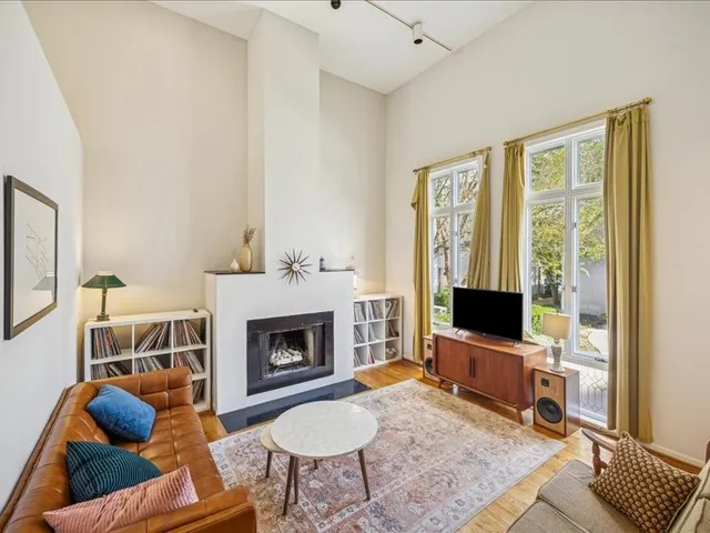 a living room with furniture a rug and a fireplace