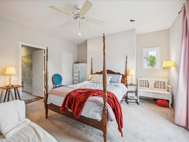 a bedroom with bed and a chandelier