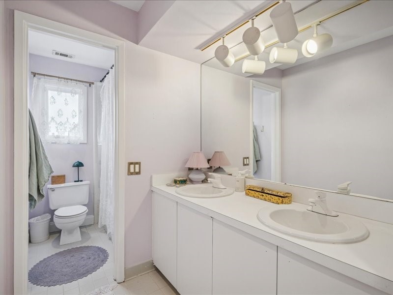 1369 Arlington Street, Unit 1369 Houston, TX 77008 - Photo 26 of 35 a bathroom with a granite countertop sink mirror and toilet