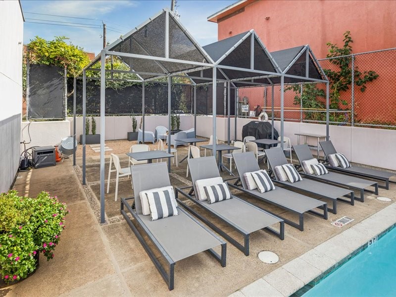 1369 Arlington Street, Unit 1369 Houston, TX 77008 - Photo 30 of 35 a roof deck with table and chairs potted plants with glass windows