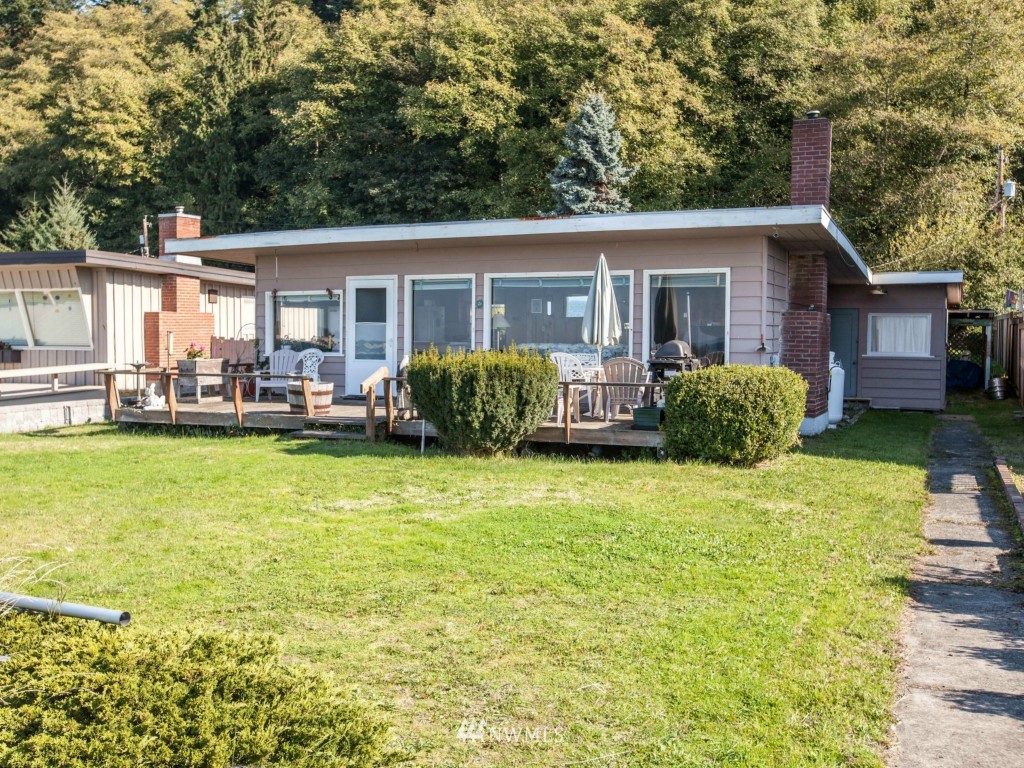 6378 South Bay Road Freeland, WA 98249 - Photo 9 of 25 a house view with swimming pool in front of it