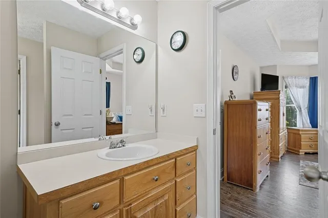 a bathroom with a sink a mirror and a shower