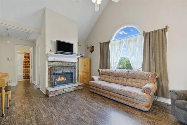 a living room with furniture a flat screen tv and a fireplace