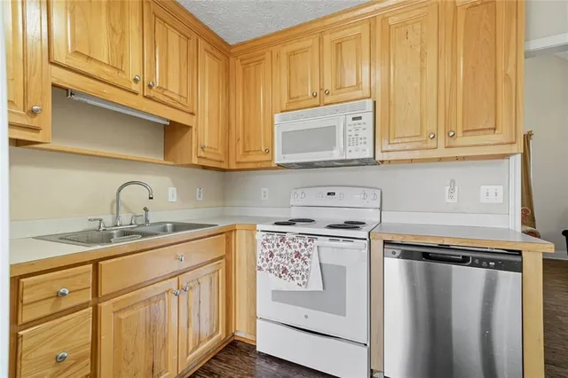 a kitchen with stainless steel appliances granite countertop a sink stove and cabinets