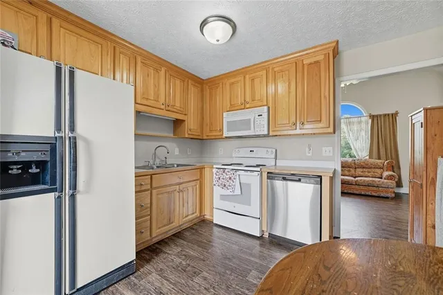 a kitchen with kitchen island a sink stainless steel appliances and cabinets