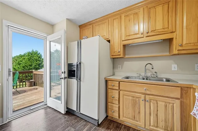 a kitchen with stainless steel appliances granite countertop a refrigerator and a sink