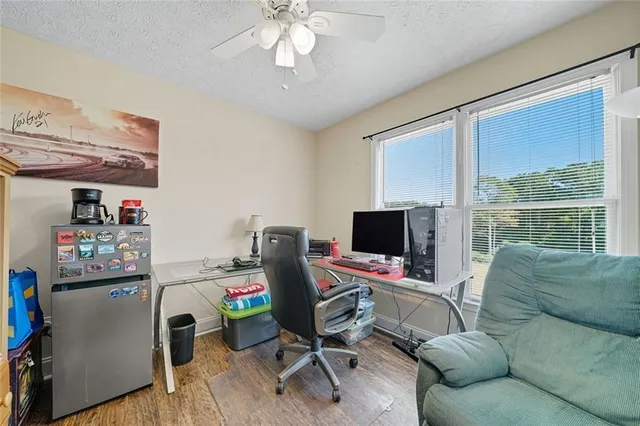 a view of a livingroom with workspace and a window